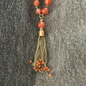 Matching necklace and bracelet orangish in color bracelet measurements at 7-8 in
